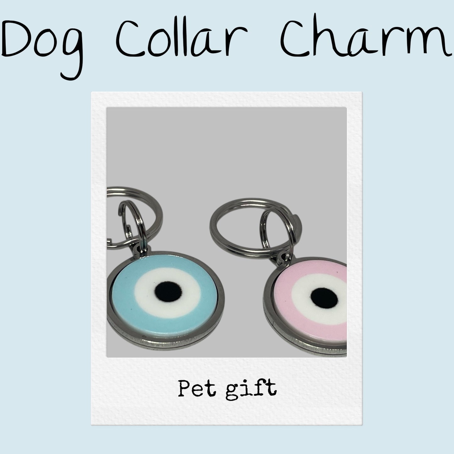 Two dog collar charms with colorful eye designs on a light gray background.