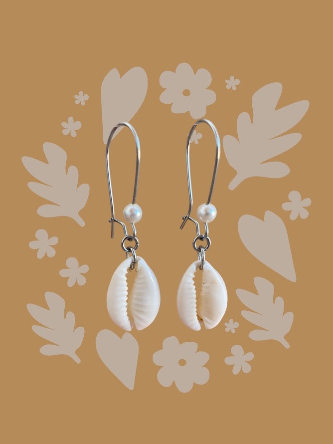 Shell earrings with pearls on a decorative brown background
