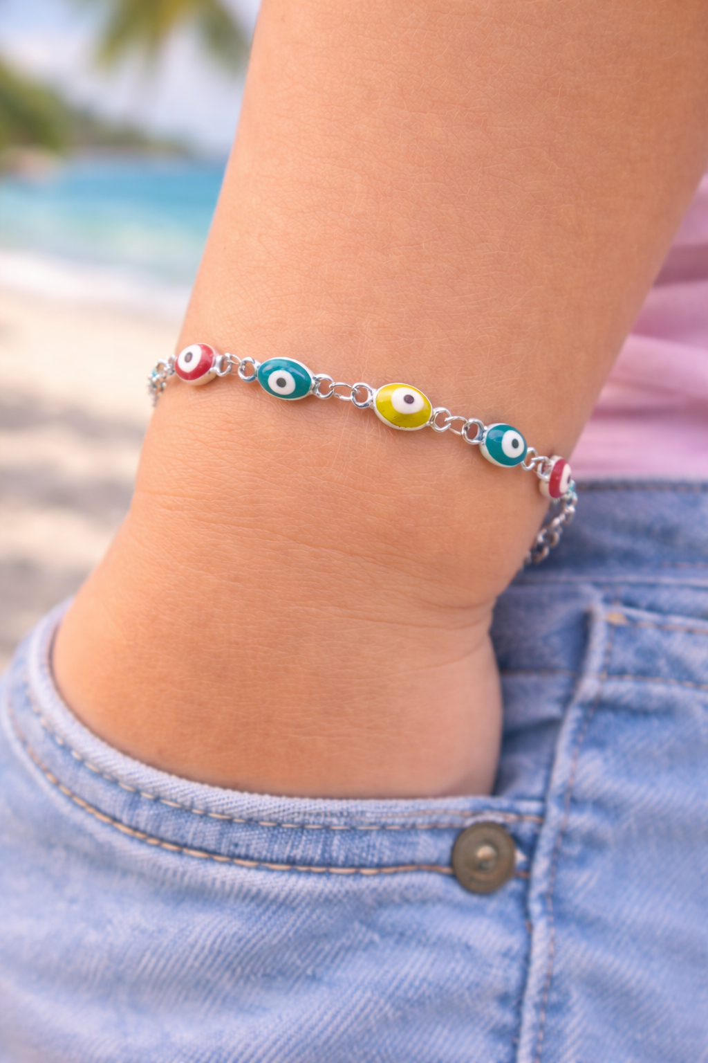 Children's bracelet with a blue enamel evil eye charm in stainless steel, lightweight adjustable jewelry inspired by Greek tradition.