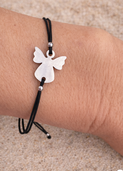 Minimalist guardian angel bracelet featuring a black macrame cord and protective angel charm, handmade for women and men.