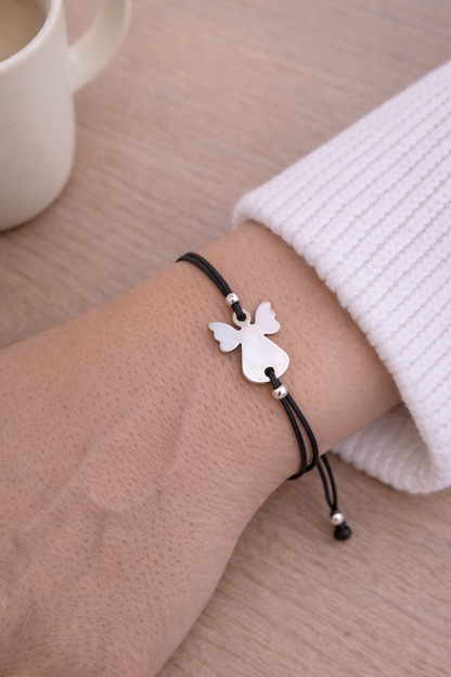 Handmade guardian angel bracelet with an adjustable black macrame cord and angel charm, a thoughtful protection gift.