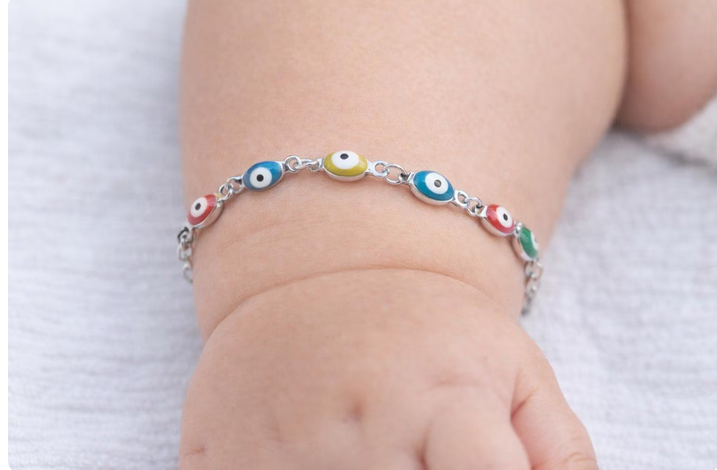 Adjustable bracelet for babies and children with a polished stainless steel enamel evil eye charm, a thoughtful gift for newborns, toddlers, and kids.