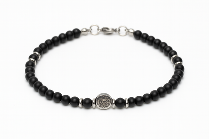 Handmade men's black onyx bracelet with a stainless steel evil eye charm, symbolic Greek protection jewelry.