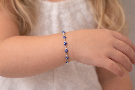 Blue adjustable evil eye bracelet for babies and children featuring a stainless steel blue enamel charm, inspired by Greek protection traditions.