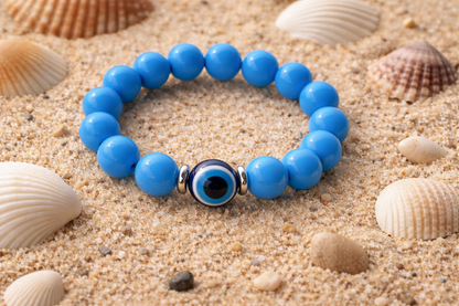 Close-up of an acrylic evil eye beaded bracelet featuring blue protective eye beads and durable elastic cord.
