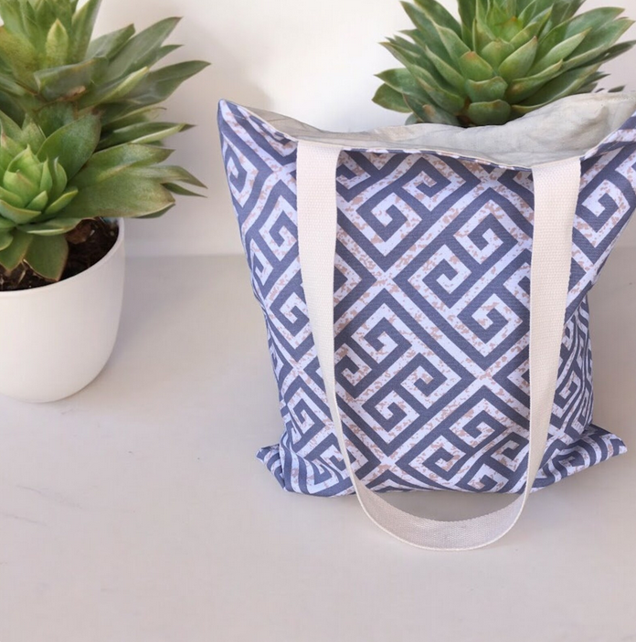 Beige and grey cotton canvas tote bag featuring the iconic Greek key motif, ideal for shopping, travel, or everyday use.