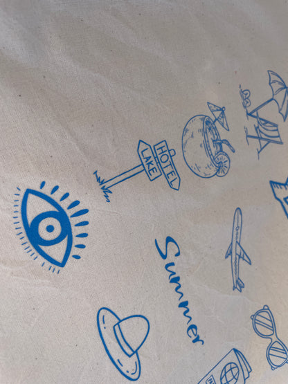 Kraft paper with blue summer-themed illustrations including an eye, airplane, and beach elements.