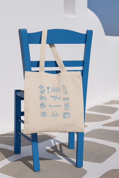 Beige tote bag with blue graphics on a blue chair against a white wall.