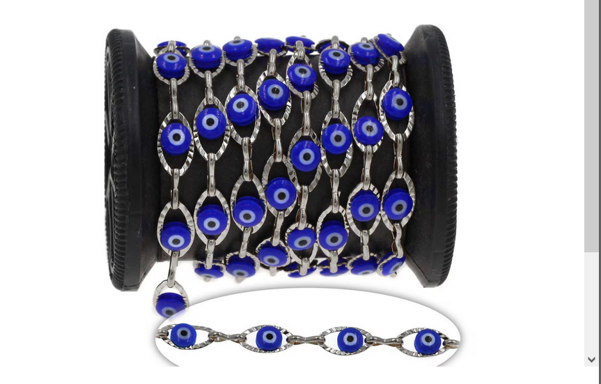 Spool of blue evil eye beads with a bracelet on a white background