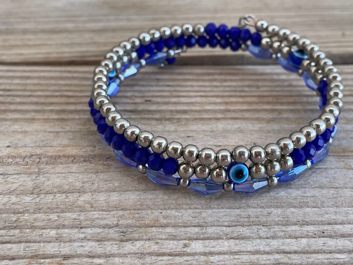 Beaded bracelet with blue and silver beads on a wooden surface