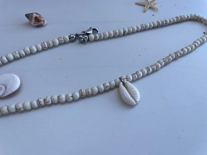 Necklace with shell pendant on a light background