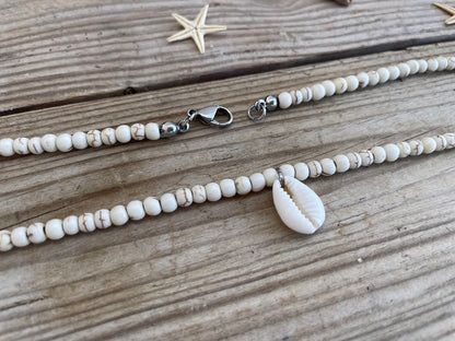 necklace with shell pendants on a wooden surface