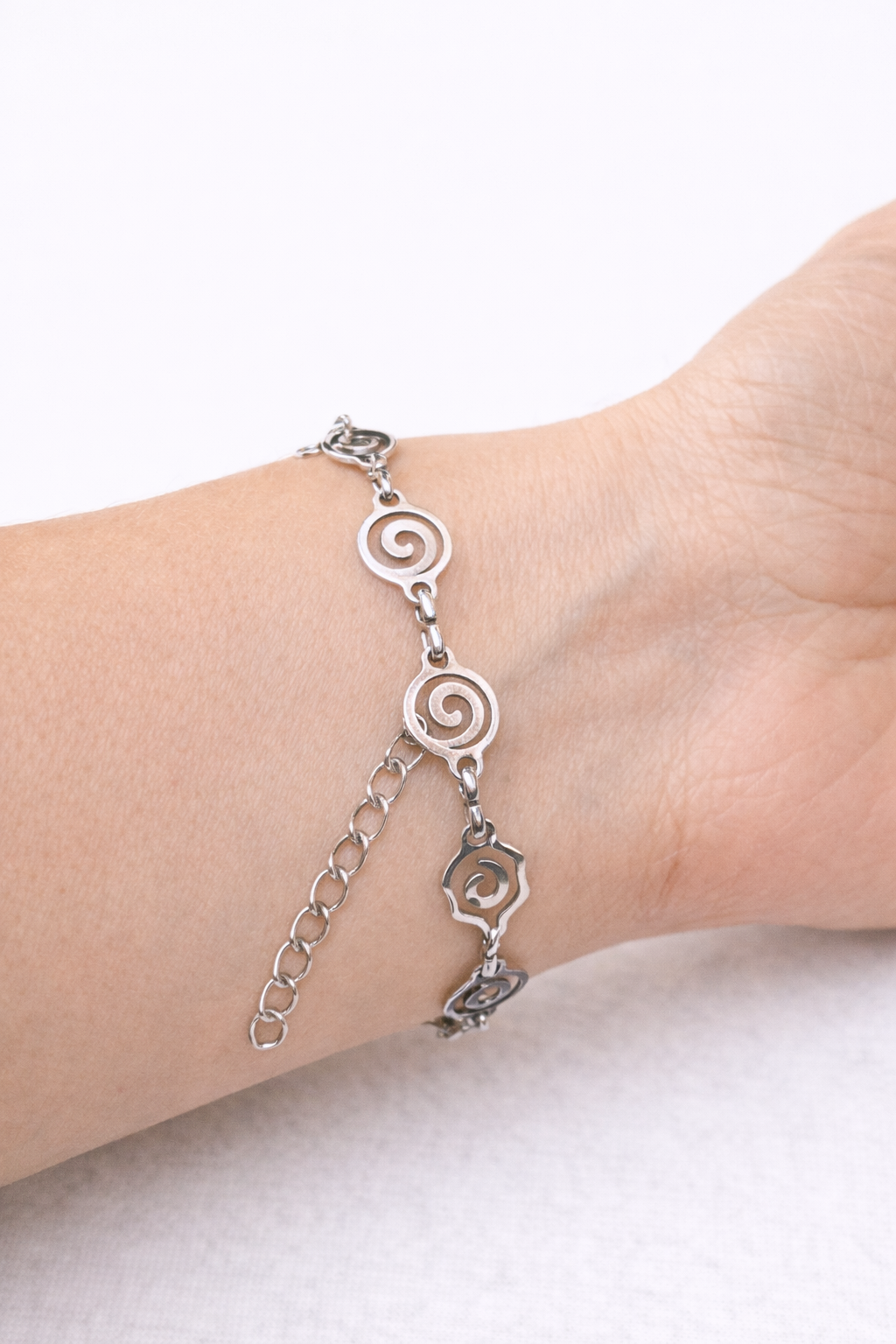 Elegant adjustable bracelet with a stainless steel spiral or rhombus design, lightweight unisex jewelry inspired by minimalist fashion.