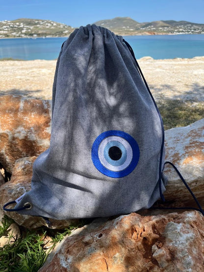 Blue-Grey Denim Drawstring Backpack with Embroidered Evil Eye
