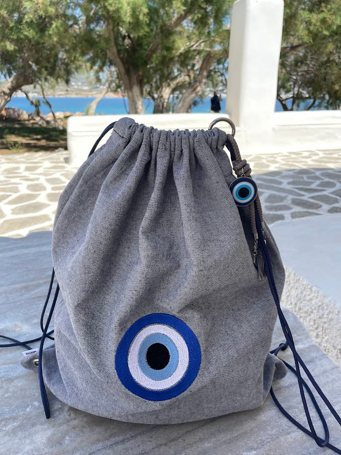 Blue-Grey Denim Drawstring Backpack with Embroidered Evil Eye