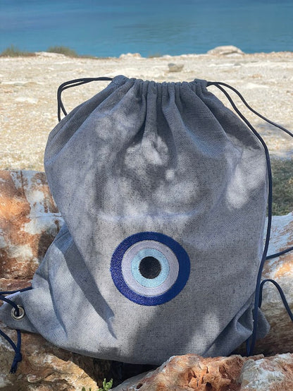 Blue-Grey Denim Drawstring Backpack with Embroidered Evil Eye