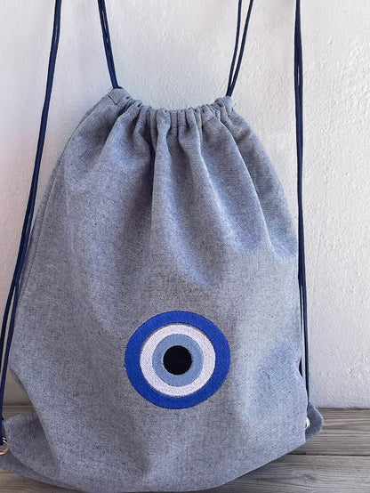 Blue-Grey Denim Drawstring Backpack with Embroidered Evil Eye