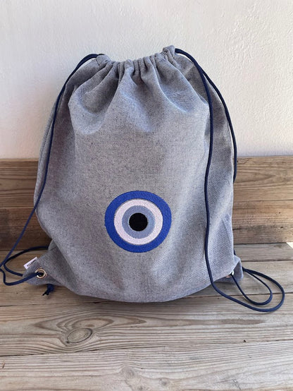 Blue-Grey Denim Drawstring Backpack with Embroidered Evil Eye