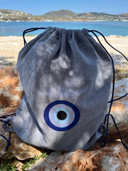 Blue-Grey Denim Drawstring Backpack with Embroidered Evil Eye