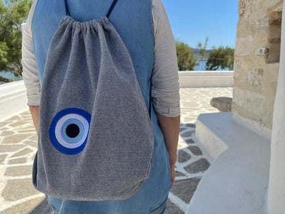 Blue-Grey Denim Drawstring Backpack with Embroidered Evil Eye