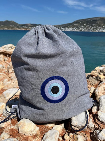 Blue-Grey Denim Drawstring Backpack with Embroidered Evil Eye
