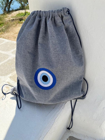 Blue-Grey Denim Drawstring Backpack with Embroidered Evil Eye