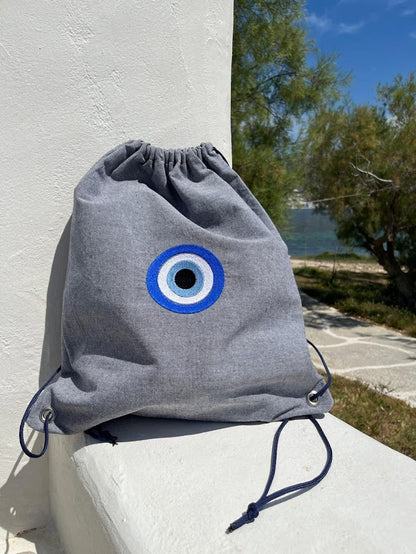 Blue-Grey Denim Drawstring Backpack with Embroidered Evil Eye
