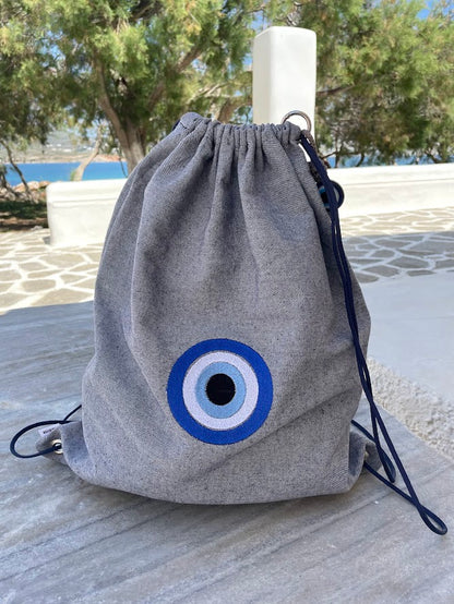 Blue-Grey Denim Drawstring Backpack with Embroidered Evil Eye