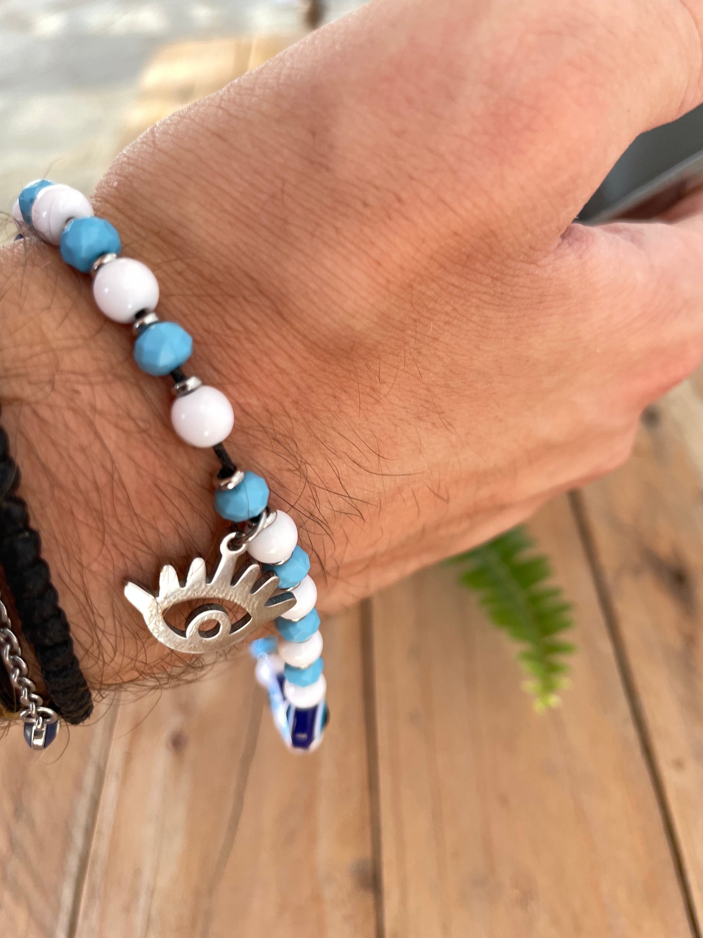 Handmade Greek evil eye phone charm with blue and white beads and stainless steel eye charm.