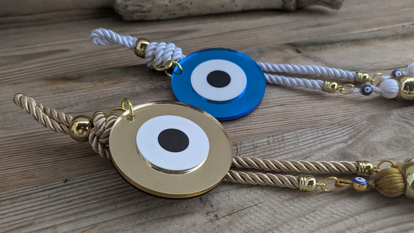 Bracelets with evil eye designs on a wooden surface