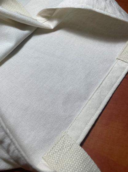Close-up of a white fabric product on a wooden surface