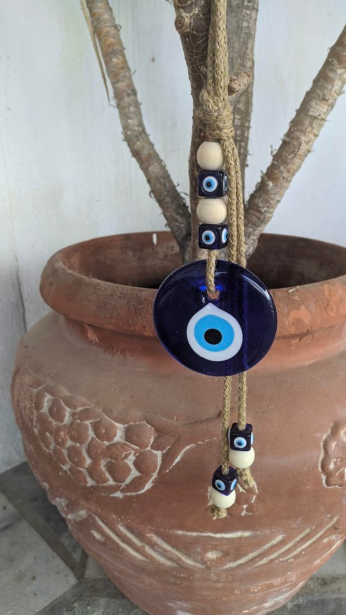 Authentic glass Greek evil eye wall hanging in a garder