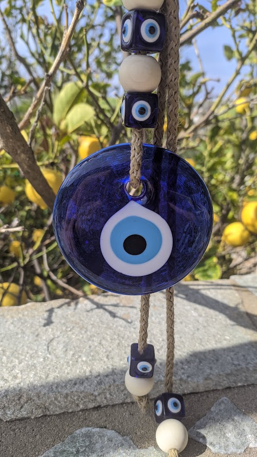 Close up to a glass evil eye wall hanging
