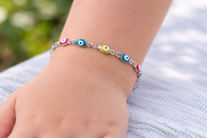 Protective baby and kids bracelet featuring a stainless steel blue enamel evil eye charm on an adjustable cord, handmade in Greece.