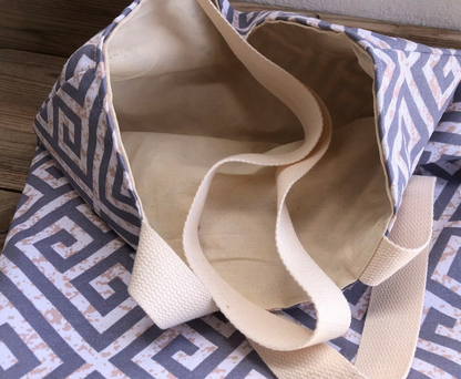 Beige tote bag on a patterned fabric surface