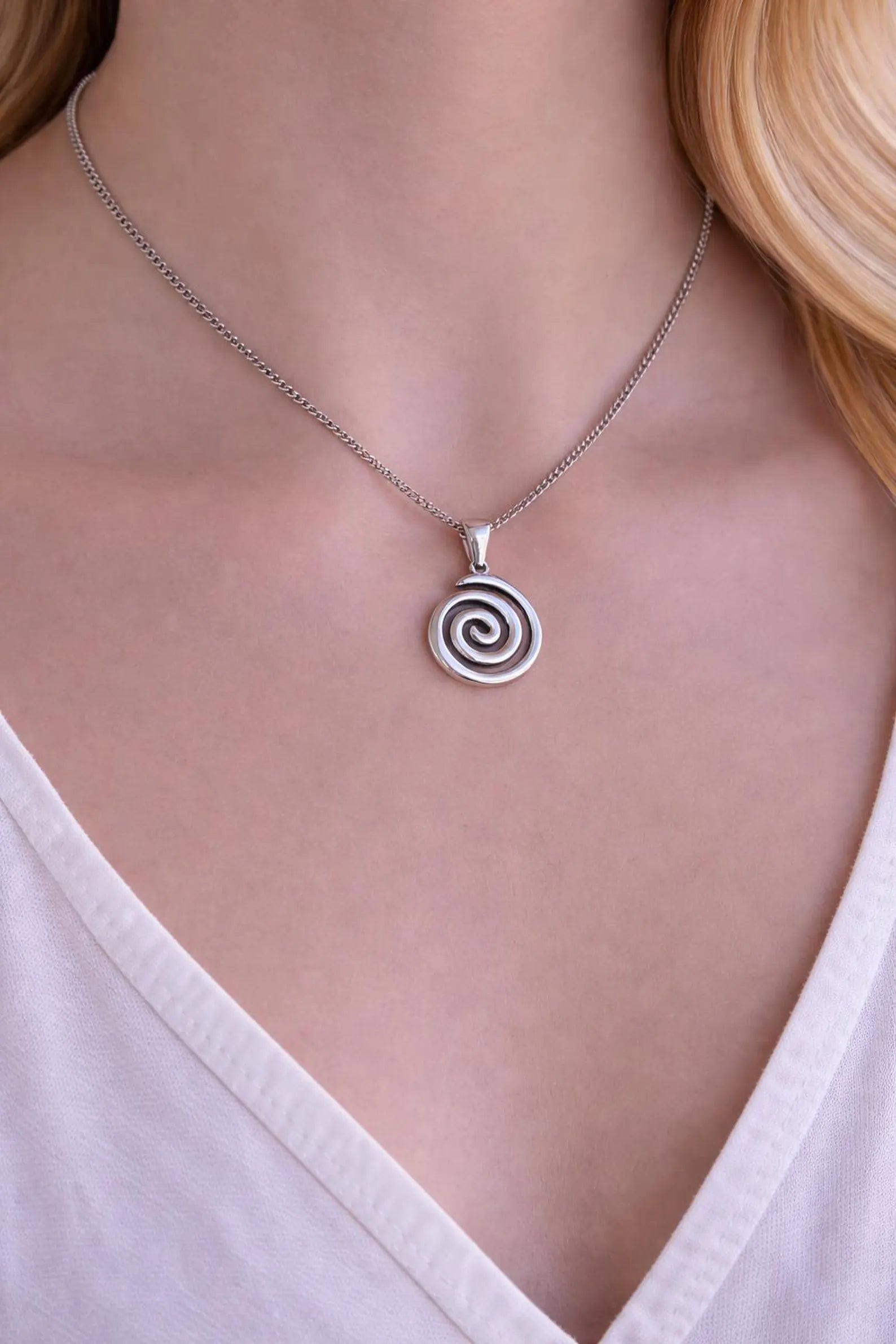 Minimalist Greek spiral pendant on a stainless steel chain, symbolic necklace inspired by ancient Greece.