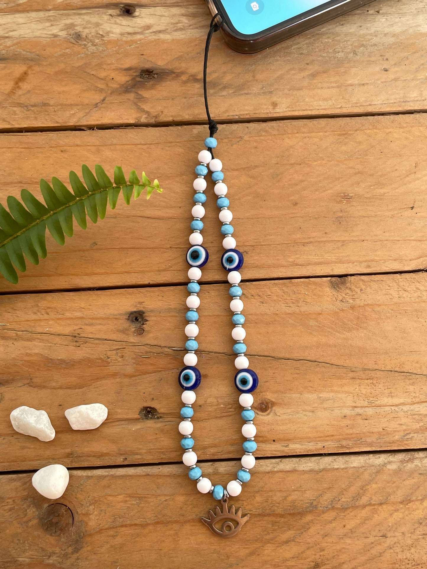 Greek evil eye phone wrist strap with handmade beaded design and lucky protection charm.