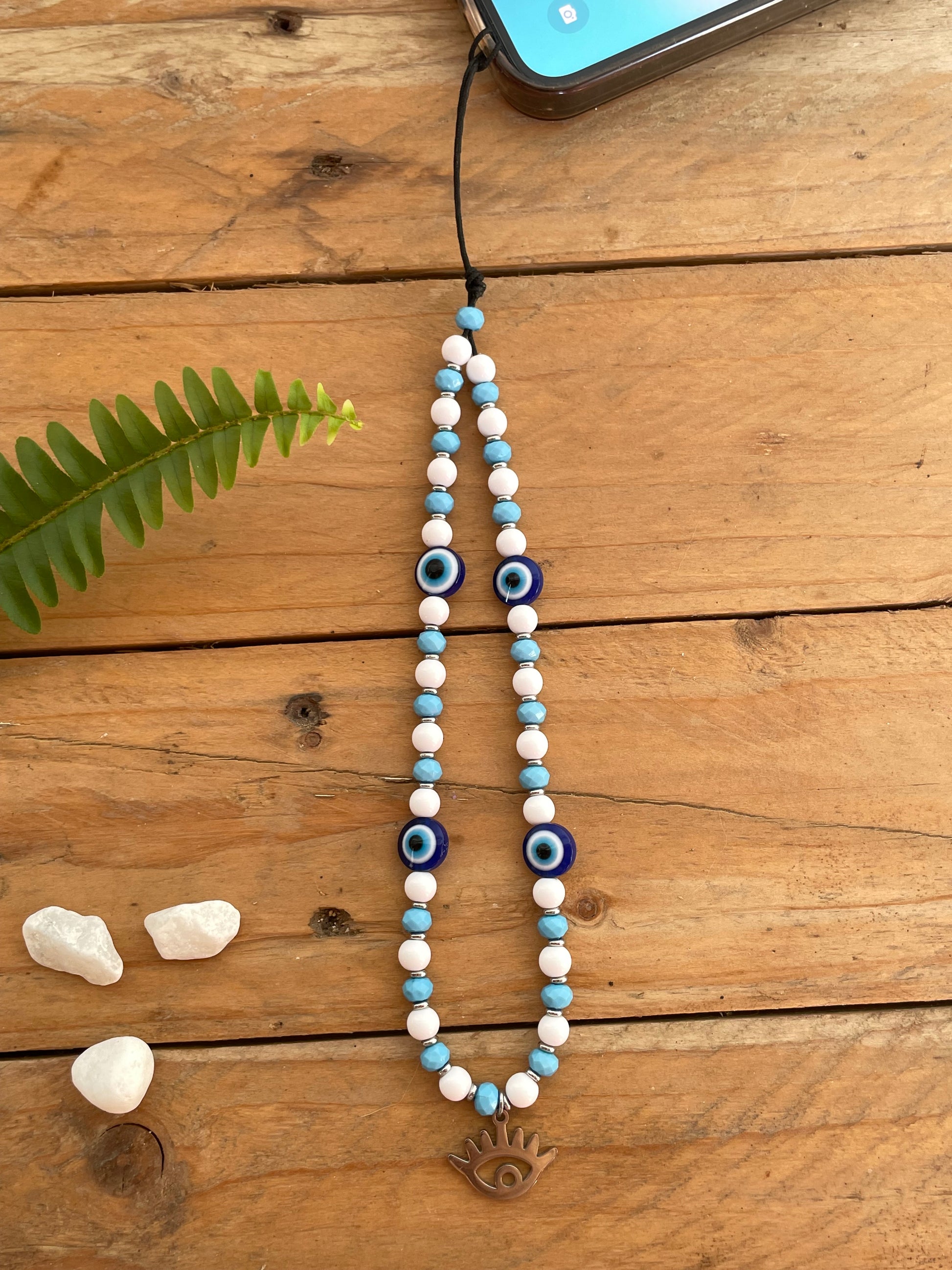 Greek evil eye phone wrist strap with handmade beaded design and lucky protection charm.