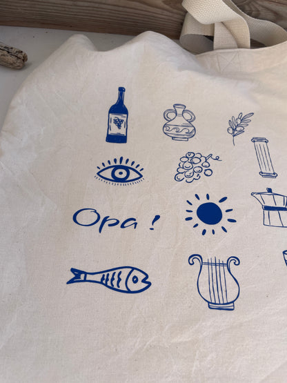 White tote bag with blue Mediterranean-themed illustrations and text.