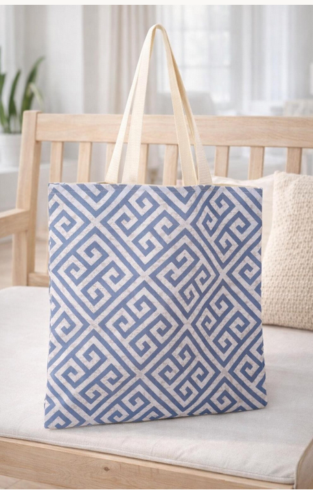 Grey canvas tote bag featuring a blue Greek key pattern, made from 100% cotton with long shoulder handles.