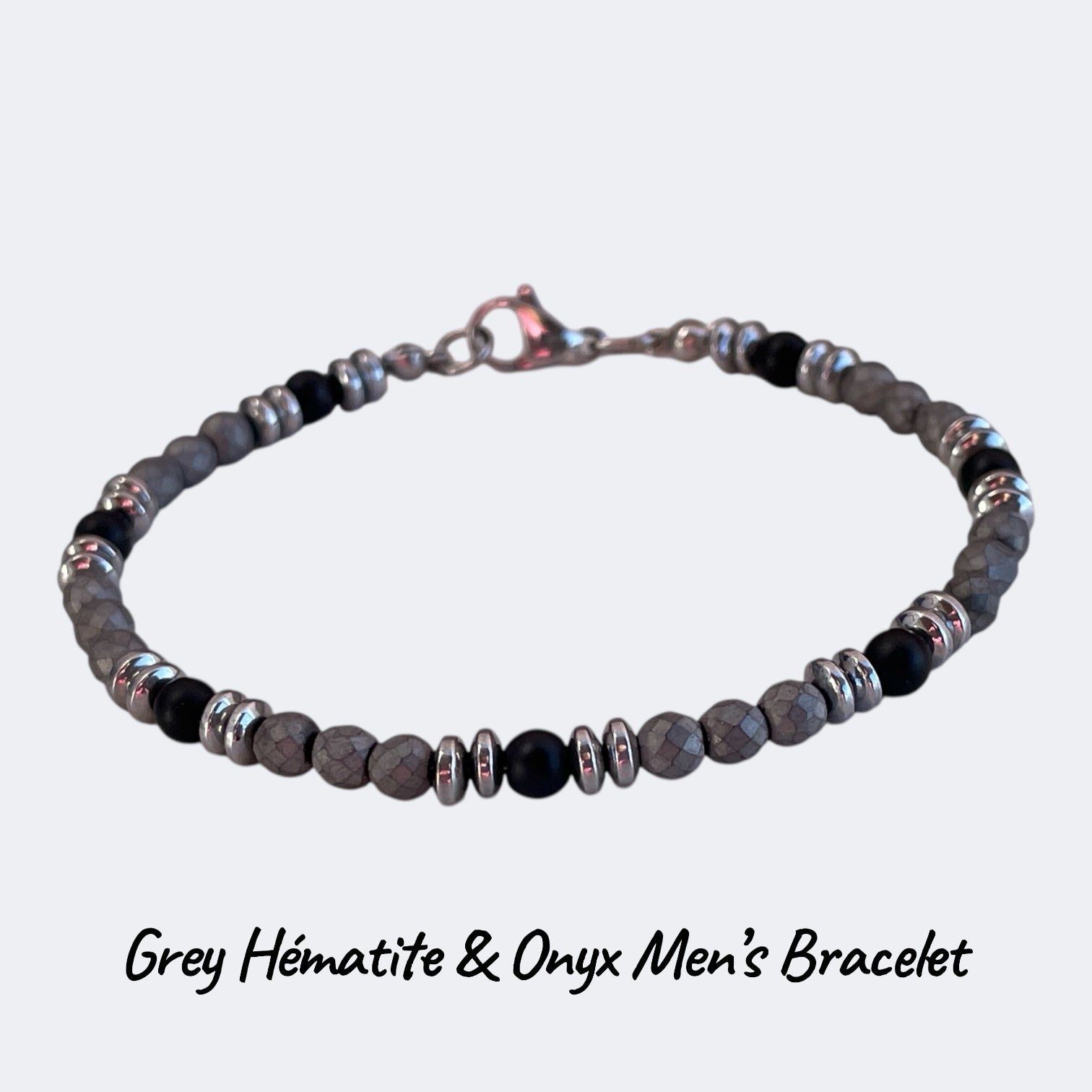 Gray hematite and onyx men's bracelet on a light gray background