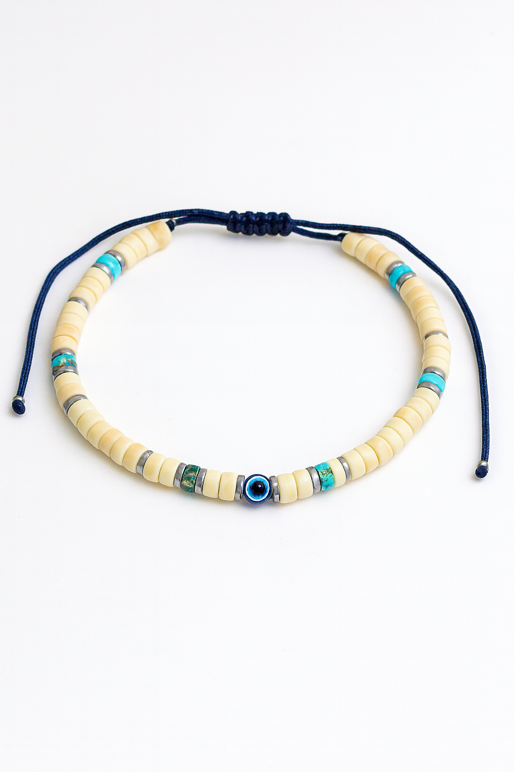 Beaded bracelet with blue and green accents on a white background