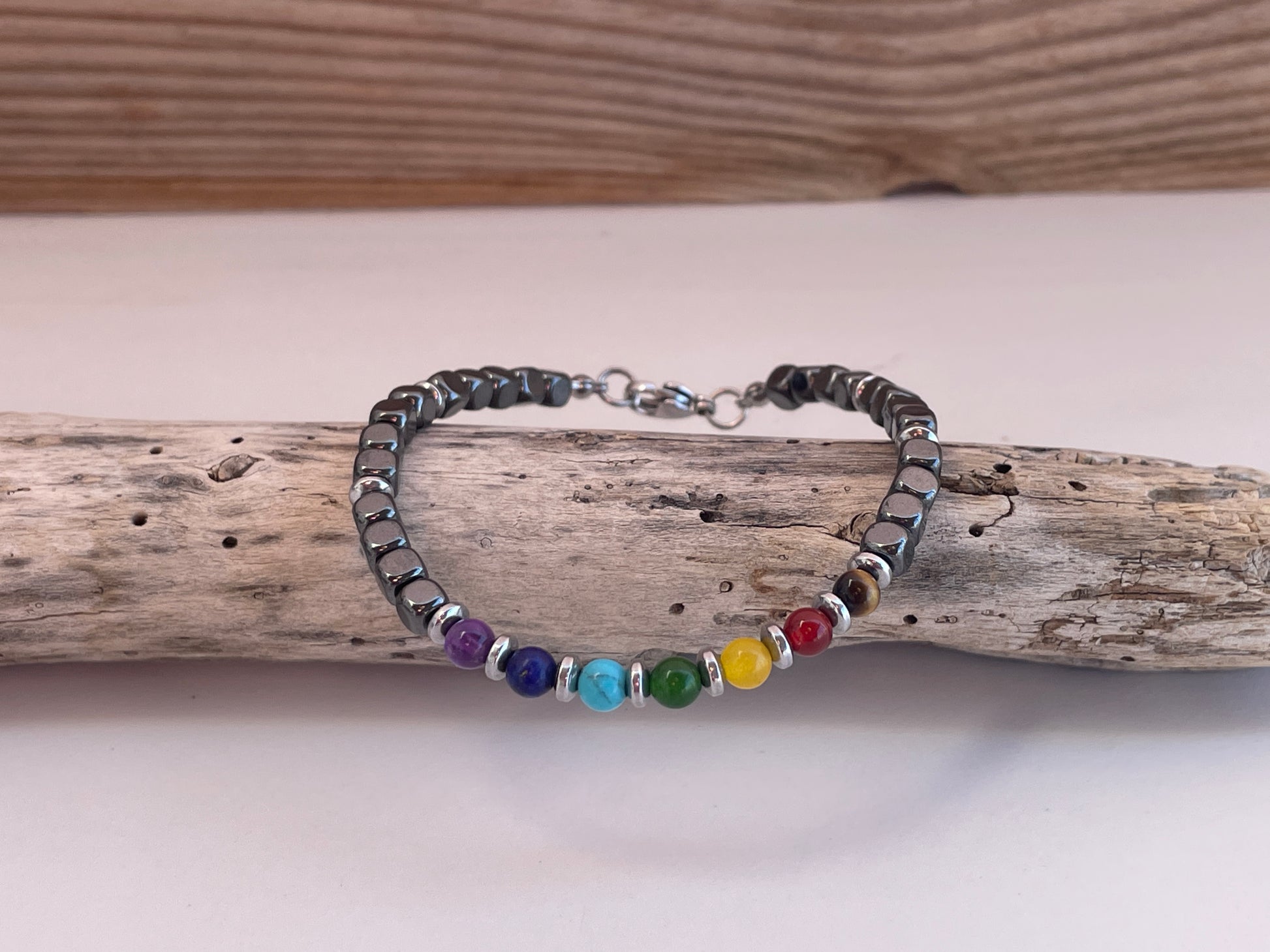 Bracelet with colorful beads on a wooden stick