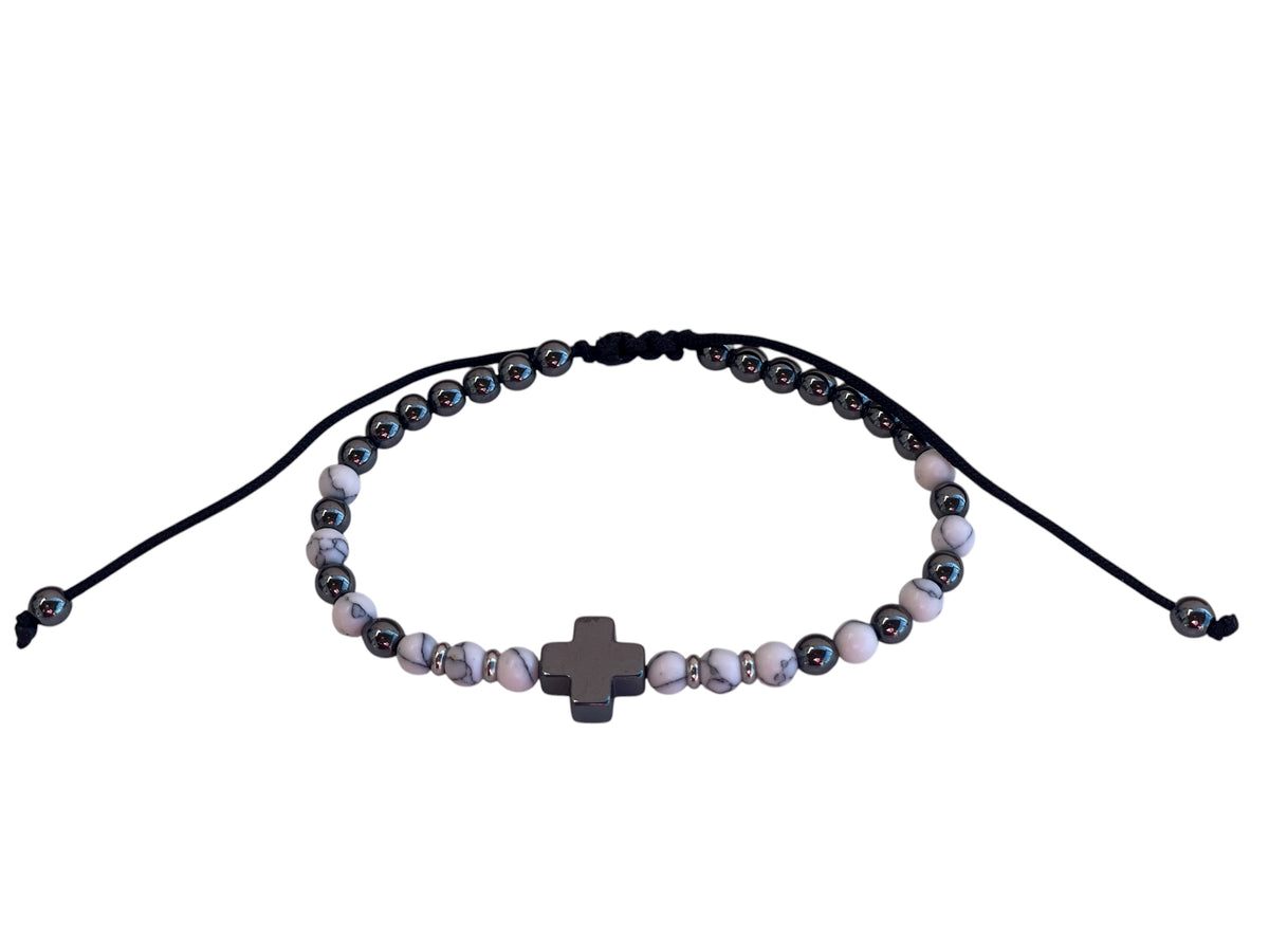 Beaded bracelet with a cross charm on a white background