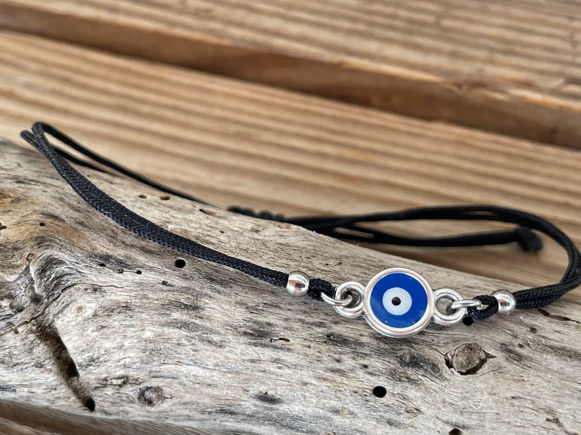 new evil eye bracelet in metal on a wood surface