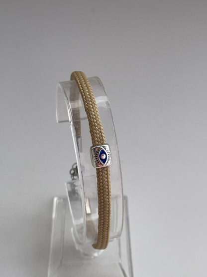 Bracelet with a silver clasp on a clear stand against a gray background