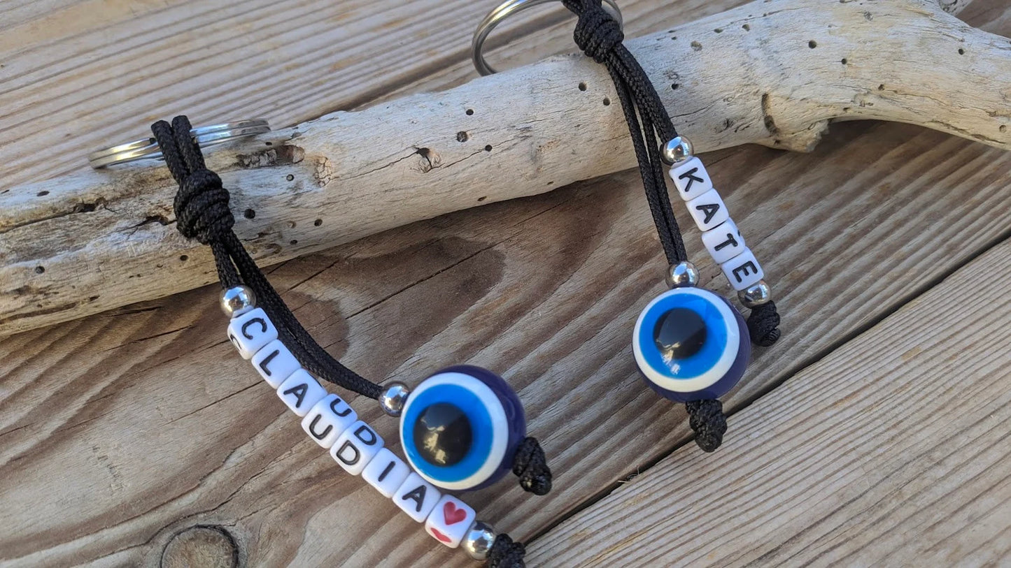 Personalized Greek evil eye keychain attached to keys, custom name keyring for everyday use and protection.