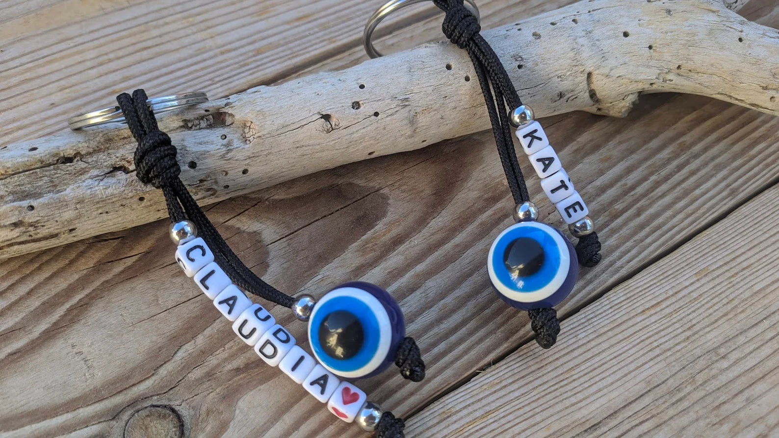 Personalized Greek evil eye keychain attached to keys, custom name keyring for everyday use and protection.