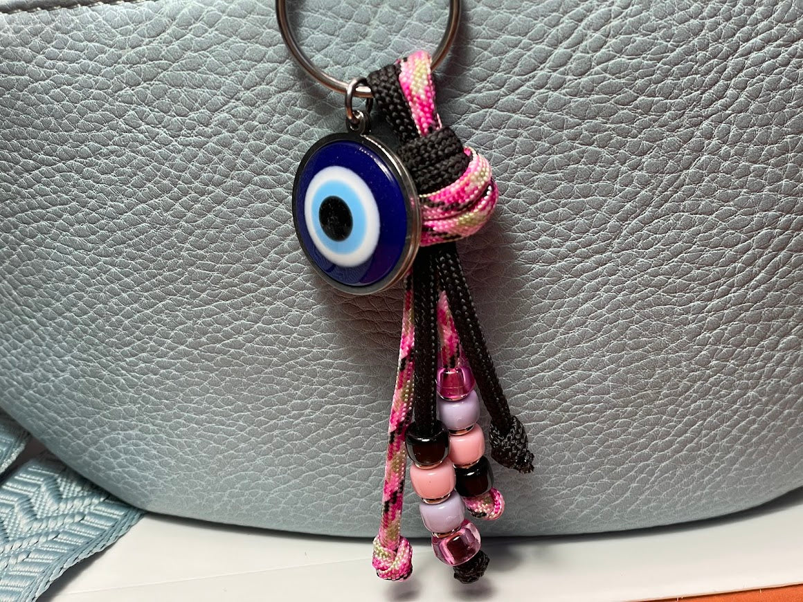 Keychain with an evil eye charm on a textured surface