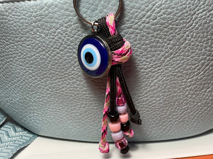 Keychain with an evil eye charm on a textured surface